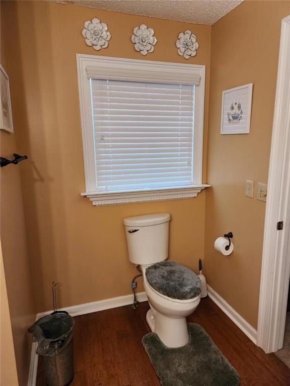 6210 Douglas Manor Ct, Douglasville, GA 30134 - bathroom featuring wood finished floors, toilet, and baseboards