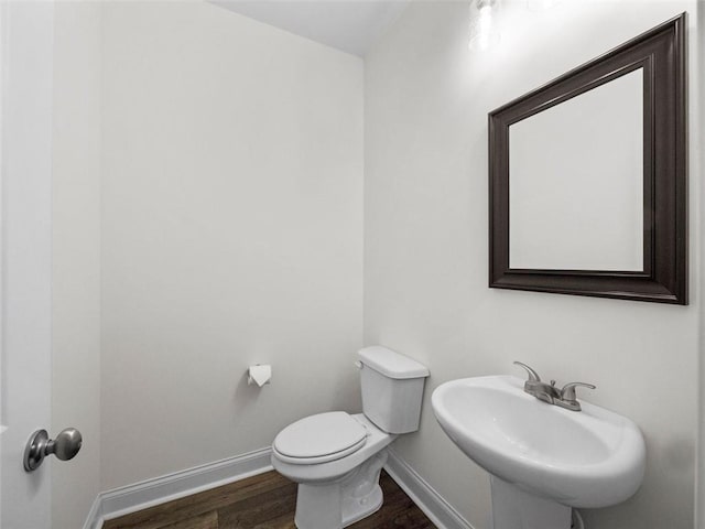 bathroom with sink, toilet, and hardwood / wood-style flooring