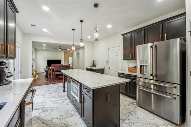 kitchen featuring arched walkways, marble finish floor, visible vents, appliances with stainless steel finishes, and open floor plan