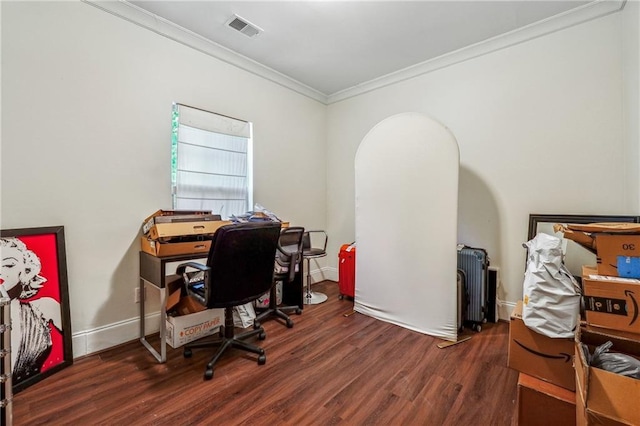 office space with ornamental molding, wood finished floors, visible vents, and baseboards