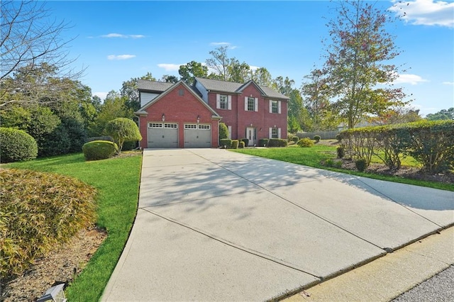 colonial home with a garage, concrete driveway, brick siding, and a front yard