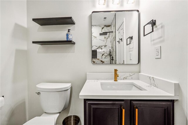 bathroom featuring toilet and vanity