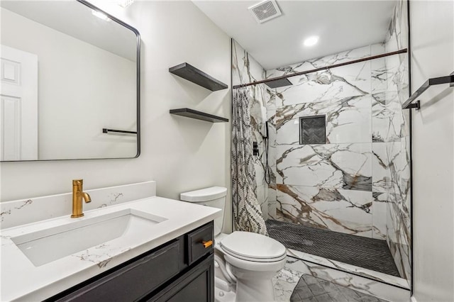 full bathroom featuring marble finish floor, a marble finish shower, visible vents, toilet, and vanity