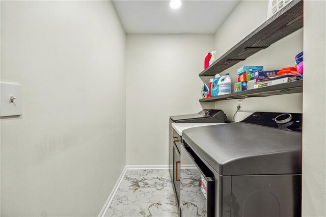 laundry area with laundry area, baseboards, marble finish floor, and independent washer and dryer