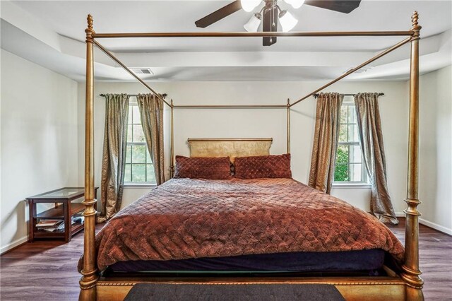 bedroom featuring a ceiling fan, baseboards, and wood finished floors