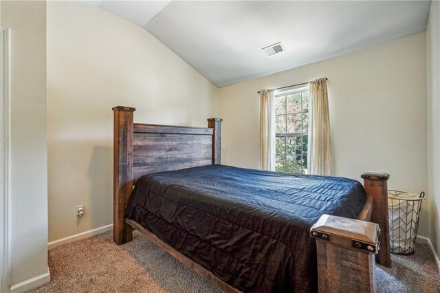 bedroom featuring baseboards, visible vents, vaulted ceiling, and carpet flooring