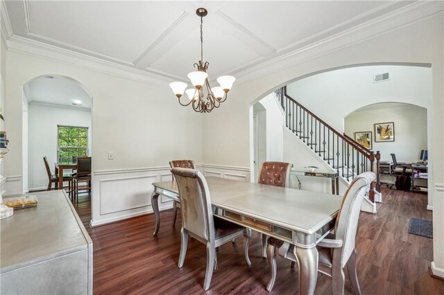 dining space with a wainscoted wall, dark wood-type flooring, visible vents, stairs, and an inviting chandelier