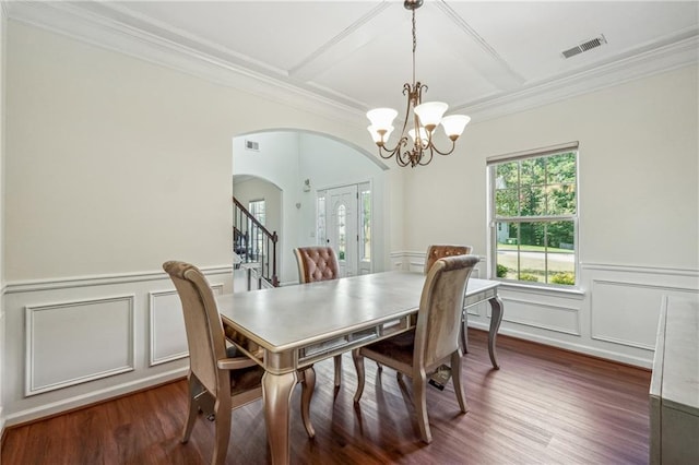 dining area with arched walkways, coffered ceiling, wood finished floors, visible vents, and stairs