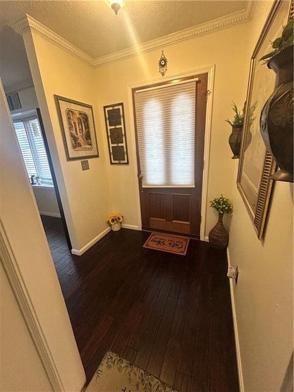 doorway featuring ornamental molding, a textured ceiling, and dark hardwood / wood-style flooring