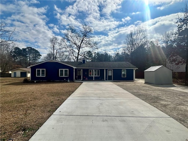 single story home with a shed and a front yard