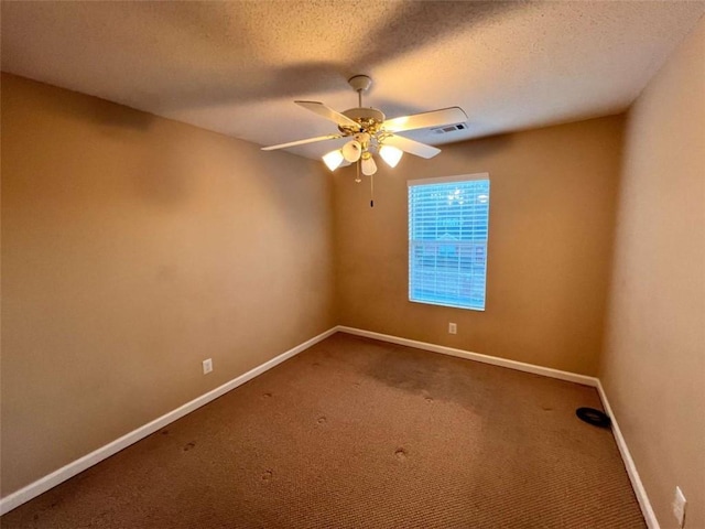 spare room featuring ceiling fan, carpet floors, and a textured ceiling