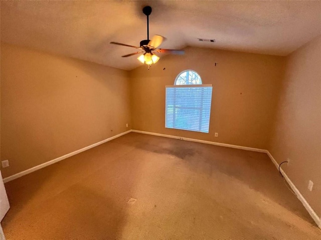 unfurnished room featuring a textured ceiling, carpet floors, ceiling fan, and lofted ceiling