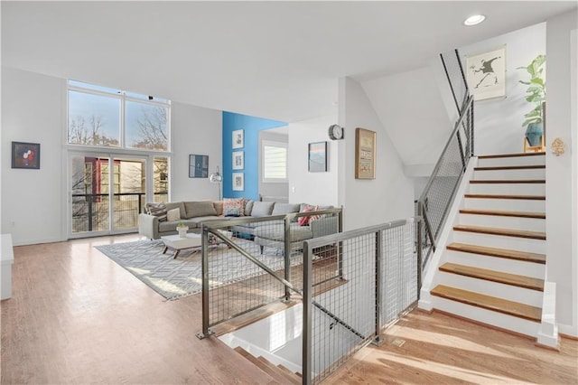 living area with stairs, baseboards, wood finished floors, and recessed lighting