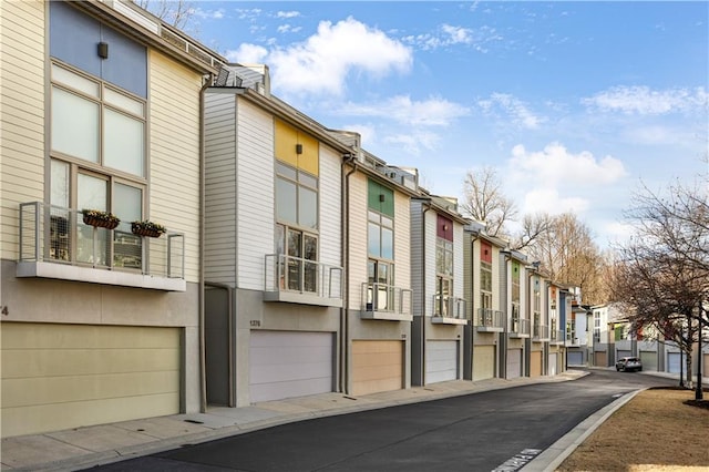 view of building exterior with a garage and a residential view