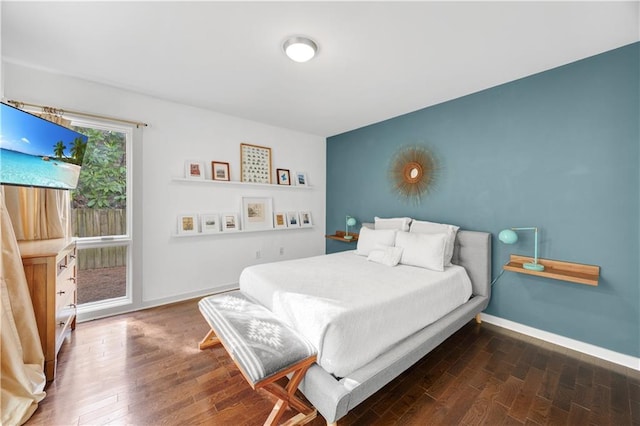 bedroom featuring baseboards and wood finished floors