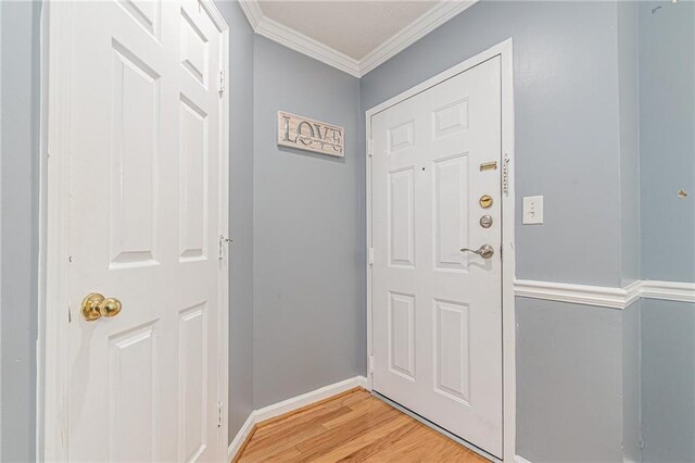 970 Sidney Marcus Blvd Unit 1217, Atlanta, GA 30324 - doorway to outside featuring crown molding, baseboards, and light wood finished floors