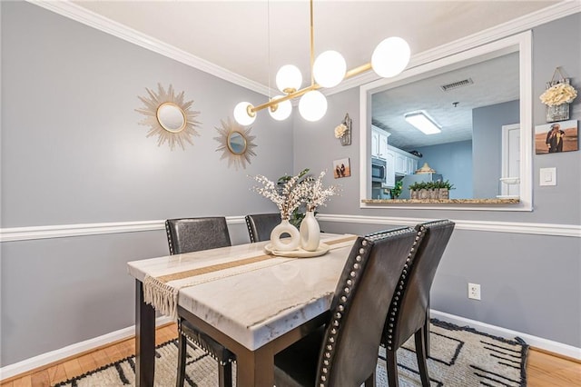 970 Sidney Marcus Blvd Unit 1217, Atlanta, GA 30324 - dining room featuring crown molding, baseboards, light wood finished floors, and visible vents