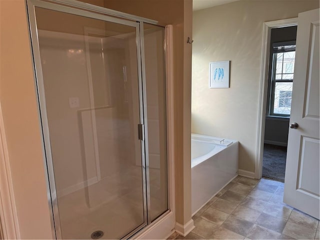 bathroom with separate shower and tub