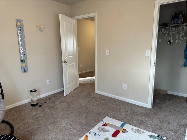 unfurnished bedroom with carpet floors and a closet