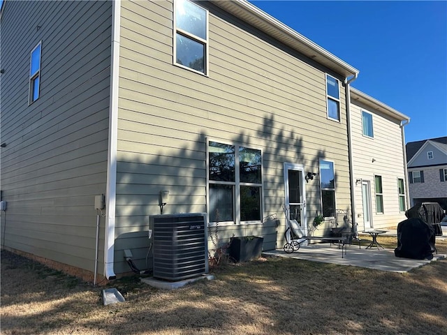 back of property featuring central AC and a patio