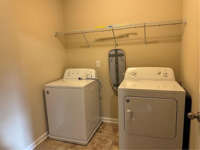 washroom with washer and clothes dryer and light tile patterned flooring