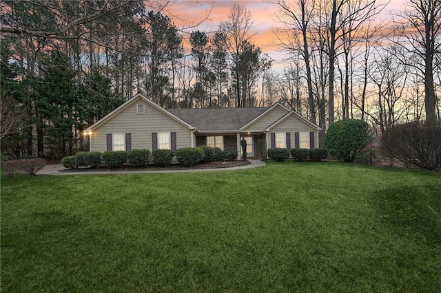 ranch-style home with a lawn