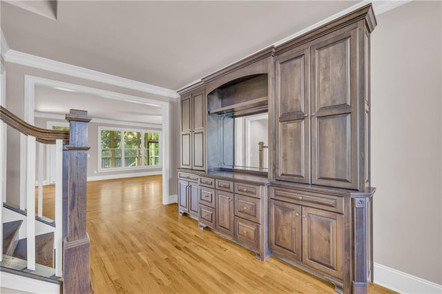 4424 Longmead Rd, Flowery Branch, GA 30542 - kitchen featuring light wood-type flooring, crown molding, and dark brown cabinetry