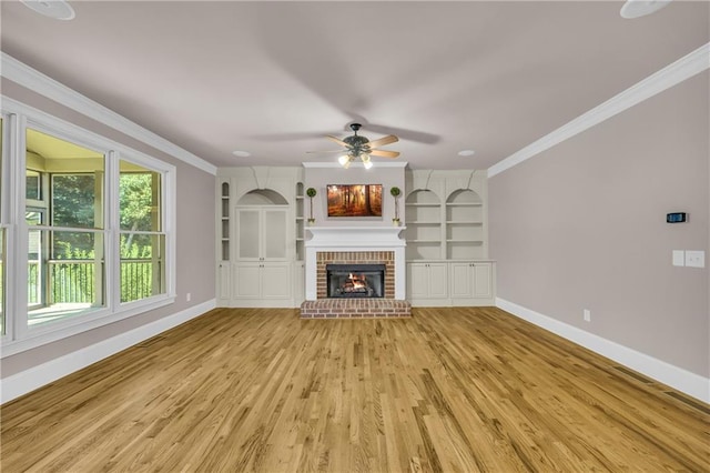 4424 Longmead Rd, Flowery Branch, GA 30542 - unfurnished living room with a ceiling fan, ornamental molding, light wood-type flooring, a fireplace, and built in features