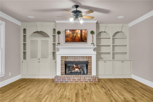 4424 Longmead Rd, Flowery Branch, GA 30542 - unfurnished living room featuring a ceiling fan, light wood-style floors, ornamental molding, a brick fireplace, and built in features