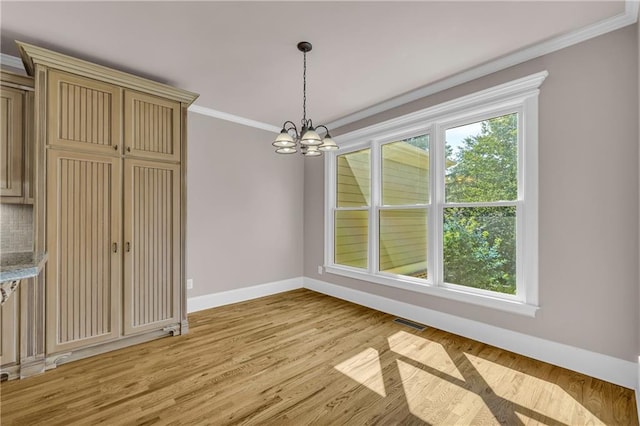 4424 Longmead Rd, Flowery Branch, GA 30542 - unfurnished dining area featuring a chandelier, crown molding, and light wood-type flooring