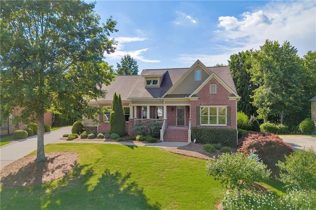 4424 Longmead Rd, Flowery Branch, GA 30542 - craftsman-style home with a porch, a front yard, and brick siding
