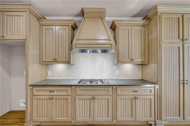 4424 Longmead Rd, Flowery Branch, GA 30542 - kitchen with custom exhaust hood, stainless steel gas cooktop, cream cabinets, decorative backsplash, and dark stone countertops