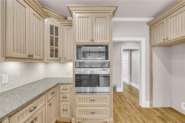 4424 Longmead Rd, Flowery Branch, GA 30542 - kitchen with stainless steel appliances, cream cabinets, crown molding, tasteful backsplash, and light wood-style flooring