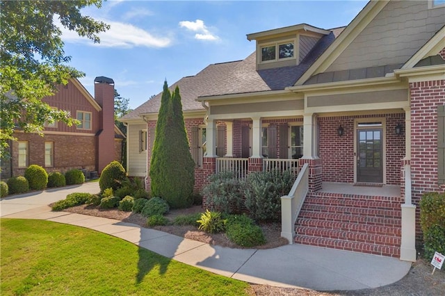 4424 Longmead Rd, Flowery Branch, GA 30542 - craftsman-style house featuring brick siding, a porch, roof with shingles, and a front yard