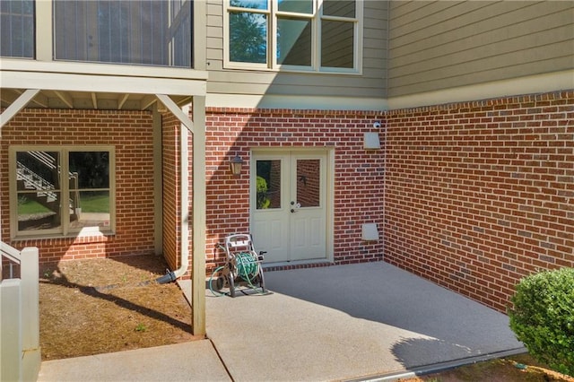 4424 Longmead Rd, Flowery Branch, GA 30542 - view of exterior entry with brick siding and a patio area