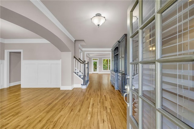 4424 Longmead Rd, Flowery Branch, GA 30542 - foyer entrance featuring light wood-style flooring, arched walkways, stairs, crown molding, and a decorative wall