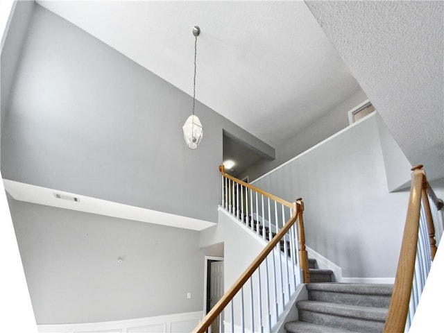 staircase featuring a notable chandelier