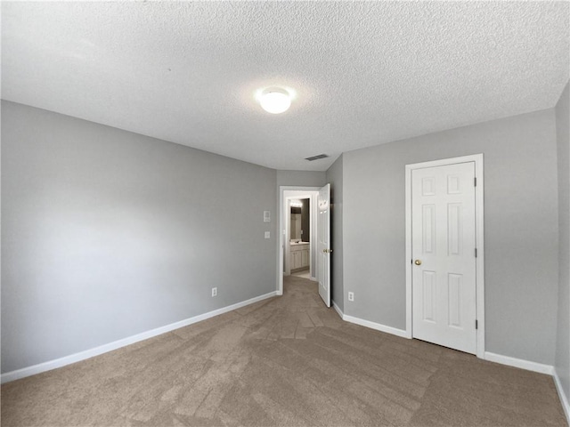 unfurnished bedroom featuring carpet flooring, a closet, and a textured ceiling