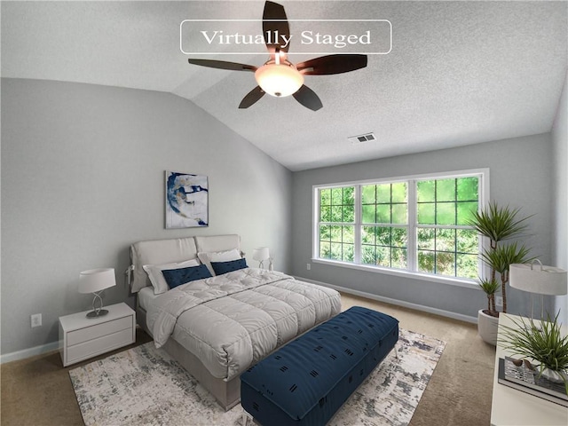 carpeted bedroom featuring ceiling fan and vaulted ceiling