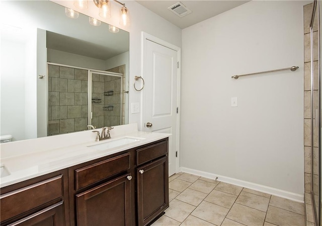 bathroom featuring toilet, tile patterned flooring, and vanity