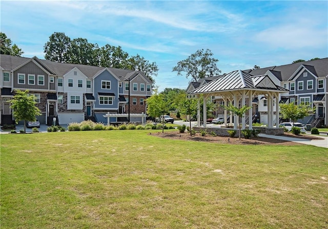 exterior space with a gazebo and a lawn