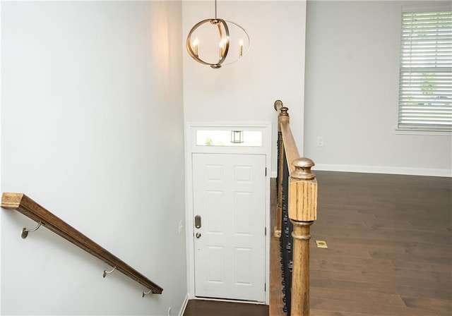 foyer featuring a notable chandelier and dark hardwood / wood-style flooring