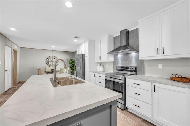 551 Fern Valley Trl, Clarkesville, GA 30523 - kitchen with wall chimney range hood, appliances with stainless steel finishes, a sink, light wood-style flooring, and recessed lighting