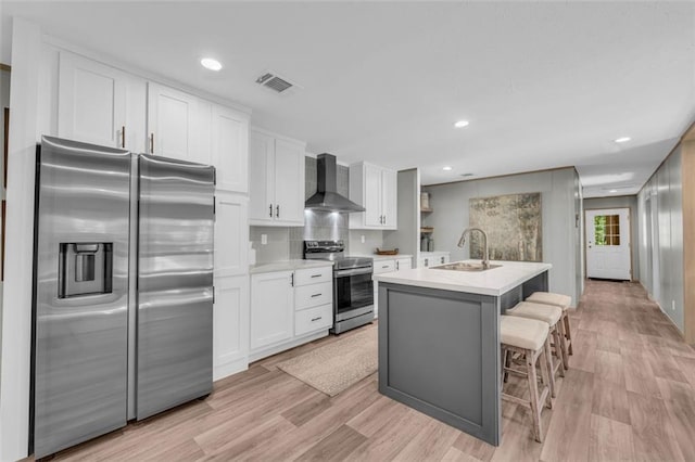551 Fern Valley Trl, Clarkesville, GA 30523 - kitchen featuring stainless steel appliances, wall chimney exhaust hood, a sink, white cabinets, and light countertops