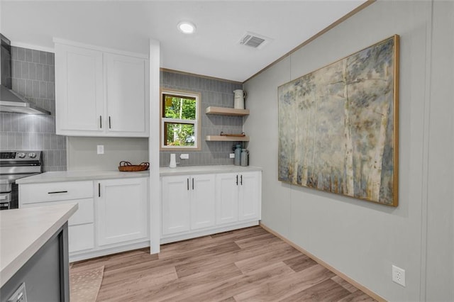 551 Fern Valley Trl, Clarkesville, GA 30523 - kitchen with stainless steel electric stove, wall chimney range hood, light countertops, decorative backsplash, and white cabinets