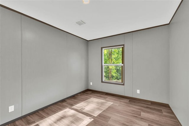 551 Fern Valley Trl, Clarkesville, GA 30523 - empty room featuring wood finished floors, ornamental molding, a decorative wall, and baseboards