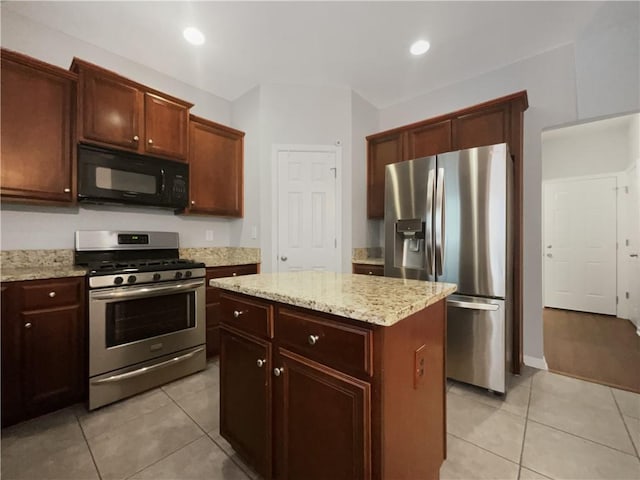 200 Pine Trl, Dallas, GA 30157 - kitchen with appliances with stainless steel finishes, light tile patterned floors, a center island, light stone countertops, and recessed lighting