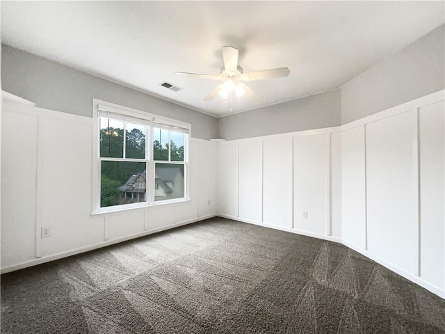 200 Pine Trl, Dallas, GA 30157 - spare room with a decorative wall, a ceiling fan, and dark colored carpet