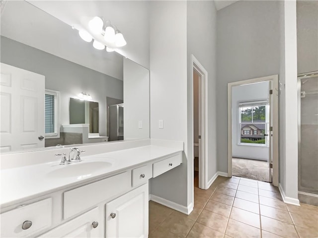 200 Pine Trl, Dallas, GA 30157 - full bathroom with vanity, a shower stall, baseboards, tile patterned floors, and a towering ceiling