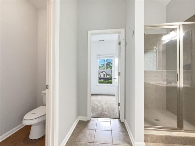200 Pine Trl, Dallas, GA 30157 - bathroom featuring toilet, a stall shower, tile patterned flooring, and baseboards